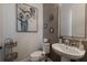 Stylish powder room with pedestal sink and decorative artwork at 5233 Blossom Cv, Lakewood Ranch, FL 34211