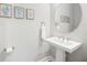 Stylish powder room with pedestal sink and framed art at 5255 Cicerone St, Sarasota, FL 34238