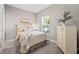 Bright bedroom with a queen bed, dresser, and window at 5255 Cicerone St, Sarasota, FL 34238