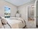 Bedroom with a queen bed, dresser, and access to private ensuite at 5255 Cicerone St, Sarasota, FL 34238