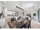 Open dining area with dark wood table and view into the living room at 5255 Cicerone St, Sarasota, FL 34238