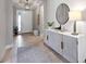 Light and airy entryway with wood-look floors and stylish console table at 5255 Cicerone St, Sarasota, FL 34238