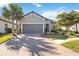 Single-story home with gray garage door and landscaped yard at 5255 Cicerone St, Sarasota, FL 34238