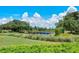 Landscaped area with a wooden bridge over a pond at 5255 Cicerone St, Sarasota, FL 34238