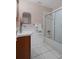 Bathroom features a vanity, shower/tub combo and tiled flooring at 5504 Birchwood Rd, Spring Hill, FL 34608