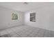 Bedroom with tile floor and two windows at 5504 Birchwood Rd, Spring Hill, FL 34608