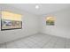 Bright bedroom featuring tile flooring and large windows at 5504 Birchwood Rd, Spring Hill, FL 34608