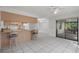 Combined kitchen and dining area with tile flooring and breakfast bar at 5504 Birchwood Rd, Spring Hill, FL 34608