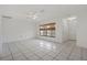 Living room with tile floors, large window and access to a bathroom at 5504 Birchwood Rd, Spring Hill, FL 34608