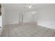 Open living room with tile floors and ceiling fan at 5504 Birchwood Rd, Spring Hill, FL 34608