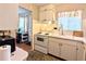 Bright kitchen featuring white appliances, tiled backsplash, and ample counter space with a window at 5918 Palm Ln # C33, Bradenton, FL 34207