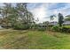 Landscaped backyard with lush greenery and a peaceful pond view at 6009 Bonaventure Pl, Sarasota, FL 34243