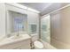 Bathroom with shower/tub combo, single sink vanity and light colored tile at 6009 Bonaventure Pl, Sarasota, FL 34243