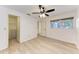 Light and airy bedroom with wood-look flooring and a large closet at 6009 Bonaventure Pl, Sarasota, FL 34243