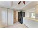 Bright kitchen features white cabinets, black appliances, and wood-look flooring at 6009 Bonaventure Pl, Sarasota, FL 34243