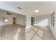 Open living room and sunroom area with light wood flooring at 6009 Bonaventure Pl, Sarasota, FL 34243