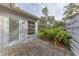 Private patio with brick pavers and lush landscaping at 6009 Bonaventure Pl, Sarasota, FL 34243