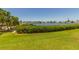 Waterfront view with lush green lawn and trees at 6200 Flotilla Dr # 241, Holmes Beach, FL 34217