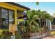 Yellow building with outdoor seating and tropical plants; Dalhousie Deck Raw Bar at 6312 Midnight Pass Rd # 301S, Sarasota, FL 34242