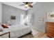 Bedroom with a ceiling fan, wood floors, and mid-century dresser at 6442 Mourning Dove Dr # 6442, Bradenton, FL 34210