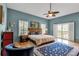 Main bedroom with wood floors and access to a private balcony at 6442 Mourning Dove Dr # 6442, Bradenton, FL 34210