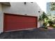 Attached garage with red door and ample parking space at 6442 Mourning Dove Dr # 6442, Bradenton, FL 34210