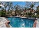 Inviting community pool and spa with lounge chairs at 6442 Mourning Dove Dr # 6442, Bradenton, FL 34210