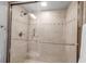 Walk-in shower with glass doors and neutral tile at 6442 Mourning Dove Dr # 6442, Bradenton, FL 34210