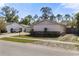 Single story home with a pink exterior, stone accents, and a driveway at 6824 Jarvis Rd, Sarasota, FL 34241