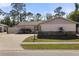 Single story home with a pink exterior and a driveway at 6824 Jarvis Rd, Sarasota, FL 34241