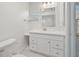 Bright bathroom featuring a white vanity, updated fixtures, and tiled floors at 7157 Fairway Bend Cir, Sarasota, FL 34243