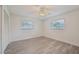 Well-lit bedroom with grey vinyl flooring and white closet doors at 7157 Fairway Bend Cir, Sarasota, FL 34243