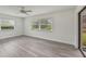 Simple bedroom with grey vinyl flooring and large windows at 7157 Fairway Bend Cir, Sarasota, FL 34243