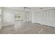 Bright bedroom with wood-look floors, and large closet at 7157 Fairway Bend Cir, Sarasota, FL 34243