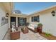 Relaxing outdoor patio with seating area and potted plants at 7157 Fairway Bend Cir, Sarasota, FL 34243