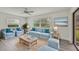 Cozy living room with light blue sofas, wooden coffee table, and hardwood floors at 7157 Fairway Bend Cir, Sarasota, FL 34243