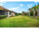 Large backyard with lush green grass and tropical landscaping at 7409 Chester Trl, Bradenton, FL 34202