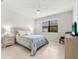 Serene bedroom featuring a striped comforter and ample space at 7409 Chester Trl, Bradenton, FL 34202