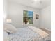 Comfortable bedroom with a floral-patterned bed, window with blinds, and a lamp at 7409 Chester Trl, Bradenton, FL 34202