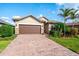 Well-maintained house with a brown garage door and nicely landscaped front yard at 7409 Chester Trl, Bradenton, FL 34202