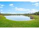 Peaceful lakefront view with homes and lush greenery at 7409 Chester Trl, Bradenton, FL 34202