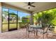 Relaxing screened patio with table and chairs, overlooking the backyard at 7409 Chester Trl, Bradenton, FL 34202