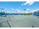 Tennis court with seating and shade at 7409 Chester Trl, Bradenton, FL 34202