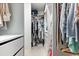 Large walk-in closet with hanging rods and drawers at 7409 Chester Trl, Bradenton, FL 34202