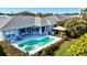 Aerial view of home's backyard featuring a pool, patio, and lush landscaping, perfect for outdoor enjoyment at 7453 Featherstone Blvd, Sarasota, FL 34238