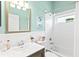 Cozy bathroom featuring seafoam walls, a large mirror, and bright white tilework at 7453 Featherstone Blvd, Sarasota, FL 34238