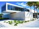 Modern beach entrance with clean lines, ample windows, and lush greenery, welcoming visitors to Siesta Beach at 7453 Featherstone Blvd, Sarasota, FL 34238