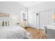 Bedroom featuring hardwood floors, bright white walls, and a comfortable bed with accent pillows at 7453 Featherstone Blvd, Sarasota, FL 34238