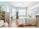 Stylish bedroom featuring wood floors, natural light from windows, and soothing pastel walls at 7453 Featherstone Blvd, Sarasota, FL 34238