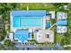 Aerial view of a large outdoor community pool with swimming lanes, a splash pad, and ample parking at 7453 Featherstone Blvd, Sarasota, FL 34238